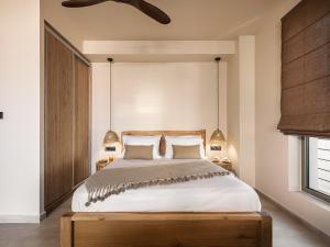 a bedroom with a large bed with a wooden headboard at Nomada Chania 2 in Chania Town