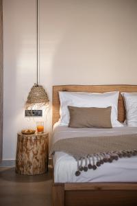 a bedroom with a bed and a table with a lamp at Nomada Chania 2 in Chania Town