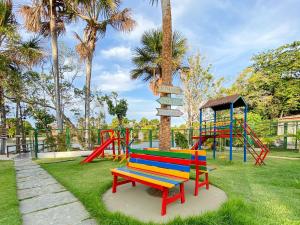 a park with a colorful bench and a playground at Condomínio Lençóis Ville Residence in Barreirinhas