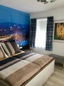 a bedroom with a large bed with a view of a city at Schönbrunn Ferienwohnungen in Vienna