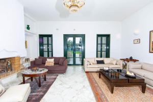 a large living room with couches and a fireplace at Arabesque House in La Marsa