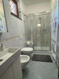 a white bathroom with a toilet and a shower at La Dolce Vita in Quiesa +31 photos