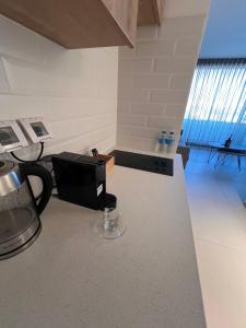 a kitchen with a counter with a coffee maker on it at סויטה מול הים סיסייד in Eilat