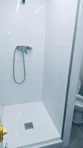 a shower in a bathroom with a toilet at Hostel 165 in Madrid