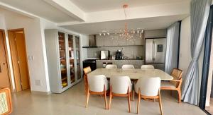 a kitchen with a large white table and chairs at Recanto Casa in Senador Canedo