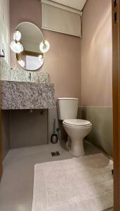 a bathroom with a toilet and a mirror at Recanto Casa in Senador Canedo