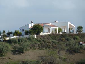 a white house on top of a hill at Las 2 Lunas in Vélez-Málaga