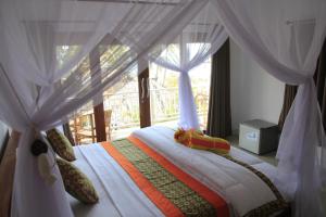 Ένα ή περισσότερα κρεβάτια σε δωμάτιο στο Amed Paradise Warung & House Bali