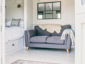 sala de estar con silla azul y cama en Coopy Corner-uk36583, en Milton Abbot