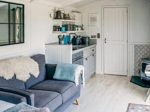 a living room with a couch and a kitchen at Coopy Corner-uk36583 in Milton Abbot