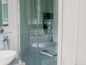 a glass shower in a bathroom with a sink at Mimis Meadow-uk36576 in Milton Abbot