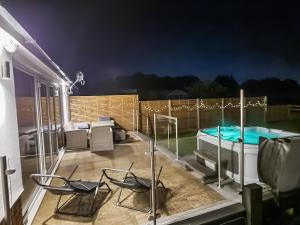 a patio with chairs and a swimming pool at Belvedere in Corfe Mullen