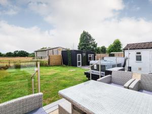 a view of a backyard with a table and chairs at Belvedere in Corfe Mullen