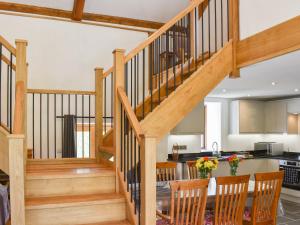 a kitchen and dining room with a staircase and a dining table at Slade Barn - Uk42977 in Highbray