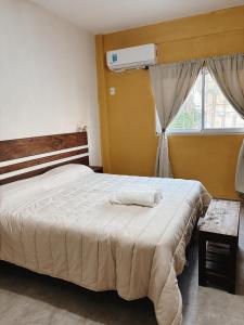 a bedroom with a large bed and a window at Mareas II in Esquina