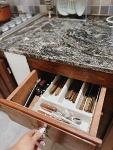 a person is opening a drawer in a kitchen counter at Mareas II in Esquina