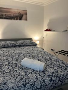 a bed with a white pillow on top of it at Amaré Guest House in Naples