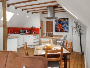 cocina y comedor con mesa y sillas en Craigdarroch Cottage, en St Fillans