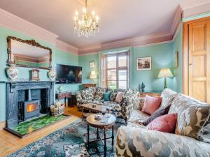 a living room with a couch and a fireplace at The Dukes Lodge 