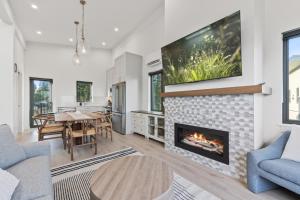 a living room with a fireplace and a dining room at Ocean View Townhouse #30 at THE BEACH HOUSE in Campbell River