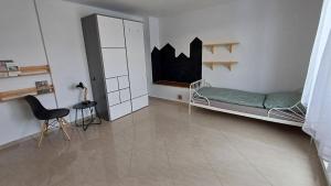 a room with a bed and a chair in it at Domček pod Borom in Suchá Hora +7 photos