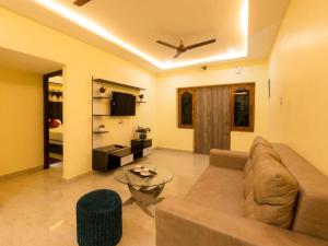 a living room with a couch and a table at Hotel Elite Park in Tirupati