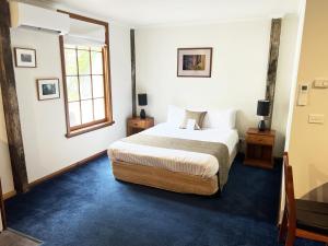 a bedroom with a bed and a window at Risby Cove in Strahan