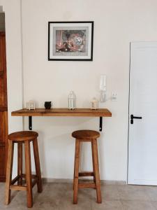 a table and two stools in a room at Mareas II in Esquina