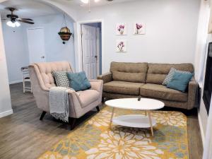 a living room with two couches and a table at Mountain Foot Condo - Near Tempe and PHX Airport in Phoenix