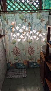 a shower curtain in a bathroom with a sink at Casas Del Mar in Manzanillo