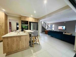 a large living room with a kitchen and a couch at Angel’s Nest Nelspruit in Nelspruit