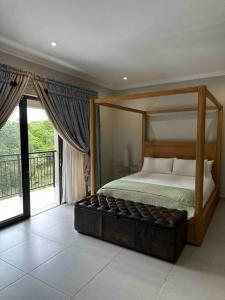 a bedroom with a canopy bed with a balcony at Angel’s Nest Nelspruit in Nelspruit