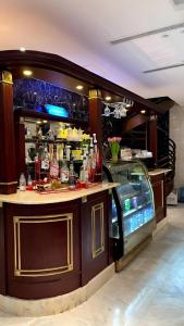 a bar in a restaurant with a counter top at Hayat Al Rose Hotel Appartment in Jeddah