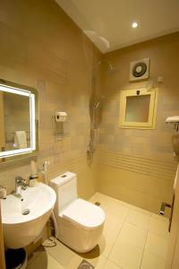 y baño con aseo y lavamanos. en Hayat Al Rose Hotel Appartment, en Yeda