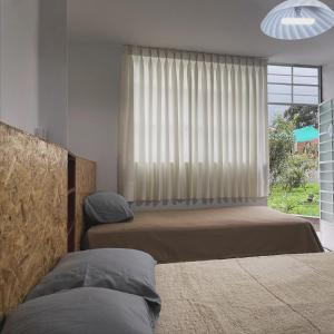 Postel nebo postele na pokoji v ubytování Hospedaje Villa Justina
