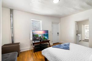 a bedroom with a bed and a flat screen tv at Studio Casita-15 min walk to Downtown Plaza in Santa Fe