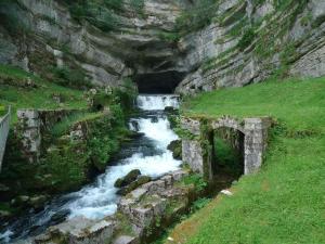 a river flowing through a mountain with a tunnel at Appartement Évillers in Évillers