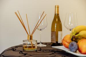 a table with a bottle of wine and two wine glasses at Palma Apartments in Herceg-Novi
