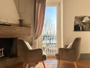 a living room with two chairs and a fireplace at Hotel Borgo Vistalago in Trevignano Romano