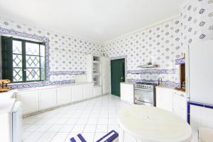 a kitchen with blue and white tiled walls at Arabesque House in La Marsa