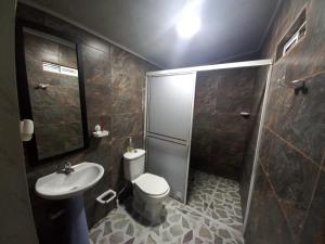 a bathroom with a toilet and a sink and a shower at APARTAMENTOS LIZ MARIA in Coveñas