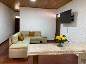 a living room with a couch and a tv at Villa Zunilda in Rivera