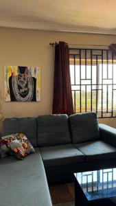 a living room with a couch and a window at Haatso House in Accra