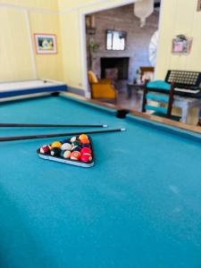 a pool table with cue balls on top of it at Chacra La Escondida in Colonia del Sacramento