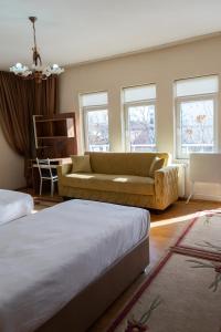 a living room with two beds and a couch at Beyaz Konak Pansiyon 2 in Gülşehir