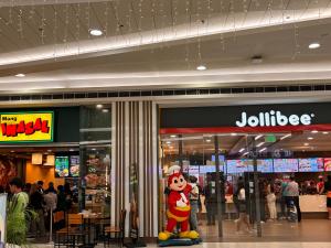 a store with a mickey mouse statue in a mall at Condotel Minimalist in Marilao