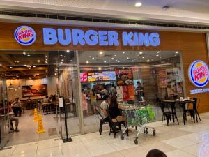 a burger king restaurant with people sitting at tables in a store at Condotel Minimalist in Marilao +1 photo