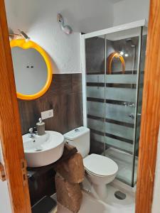 a bathroom with a toilet and a sink and a shower at Loft la Caletilla in Caleta de Sebo