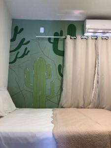 En eller flere senge i et værelse på Aconchego de Itapuã