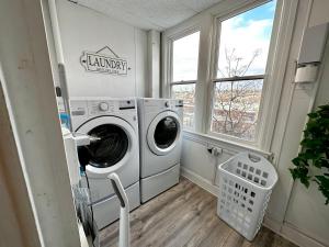 a laundry room with a washing machine and a window at 4-A Diamond in Yonkers in Yonkers